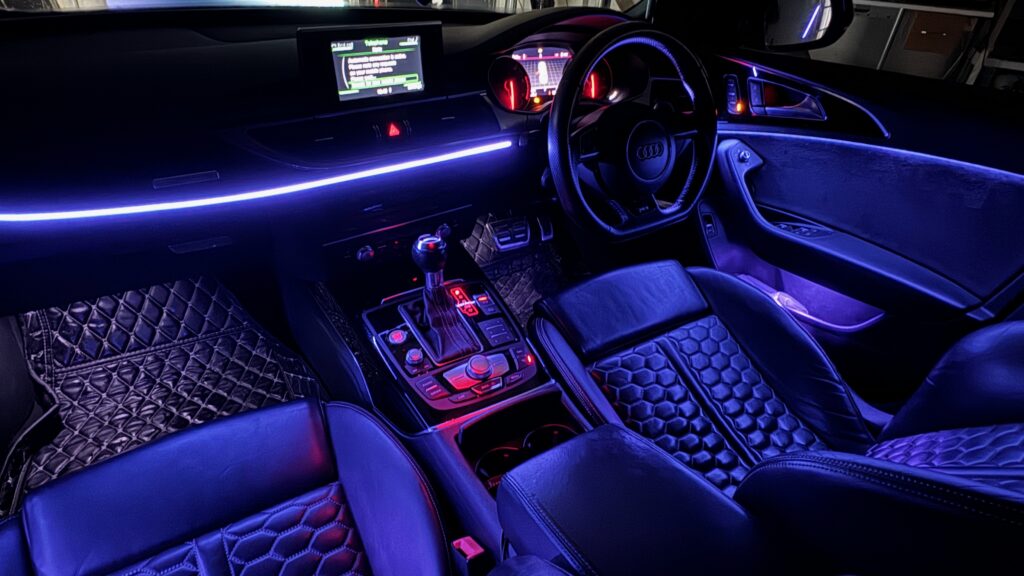 Car interior with blue ambient lighting upgrade.