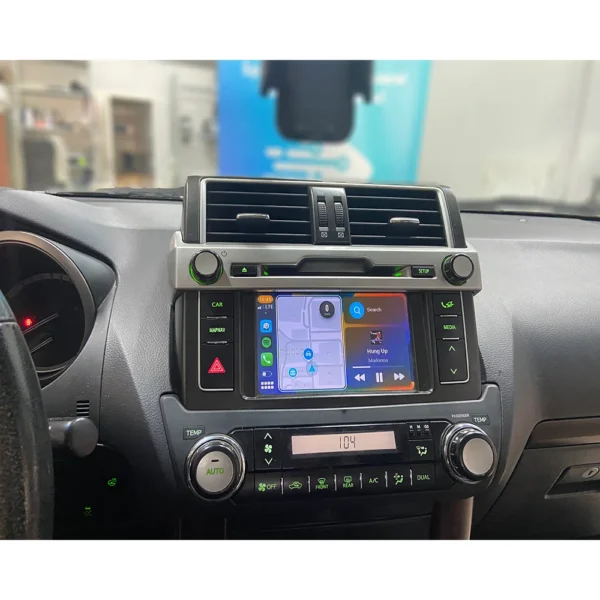 Toyota Land Cruiser's integrated Apple CarPlay and Android Auto display showing navigation and media.
