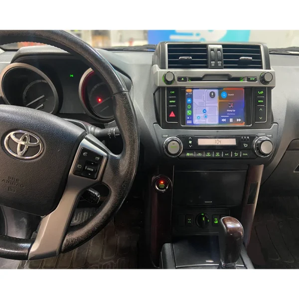 Toyota Land Cruiser dashboard featuring Apple CarPlay/Android Auto integration for navigation and entertainment.
